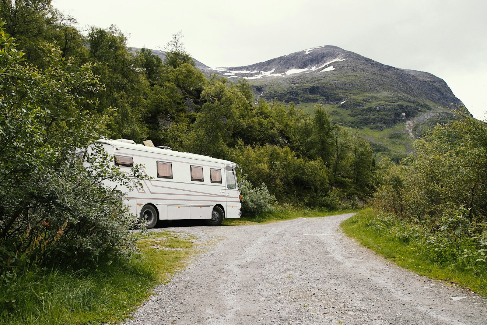 An rv parked on the side of a dirt road